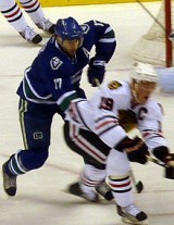 Canucks Ryan Kesler and Blackhawks Jonathan Toews battle. Image Courtesy of Wikipedia Commons.